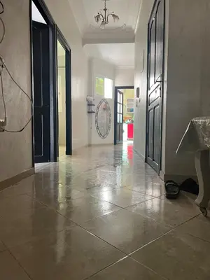 an empty hallway with doors and a tile floor at OFPPT Otmania in Meknès