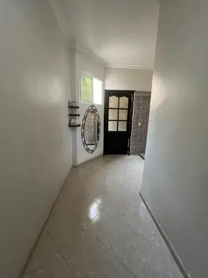 an empty hallway with a mirror and a door at OFPPT Otmania in Meknès