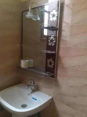 a bathroom with a sink and a mirror at شمس ميبلادن Tafoukt N' Mibladen in Midelt