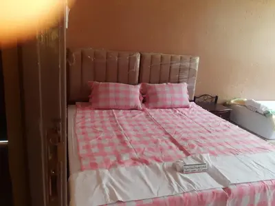 a bed with pink and white sheets and pink pillows at شمس ميبلادن Tafoukt N' Mibladen in Midelt
