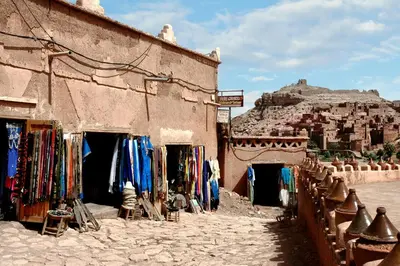 a building with a bunch of clothes outside of it at Merzouga Infinity Dunes Camp in Merzouga