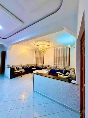 a living room with a couch and a table at appartement in Fès