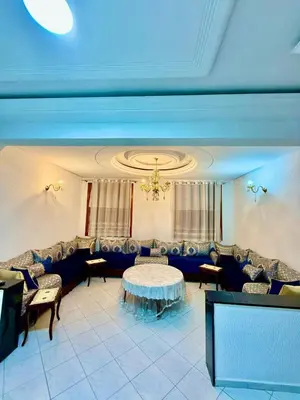 a dining room with a table and chairs at appartement in Fès