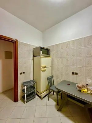 a kitchen with a table and a yellow refrigerator at appartement in Fès