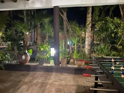 a room with people playing a game of bowling at Suite avec salle de bain privée das un beau Riad avec piscine in Aghmat
