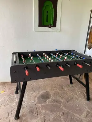 a ping pong table with a board on it at Suite avec salle de bain privée das un beau Riad avec piscine in Aghmat