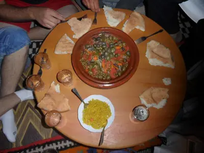 a table with a bowl of soup and a plate of food at Gite Ifoulou Tassaout in Ifoulou