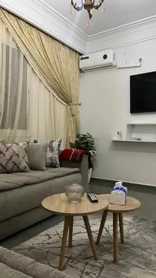 a living room with a couch and a table at A Comfortable & Modern Apartment Mhamid Marrakech in Oulad Akkou