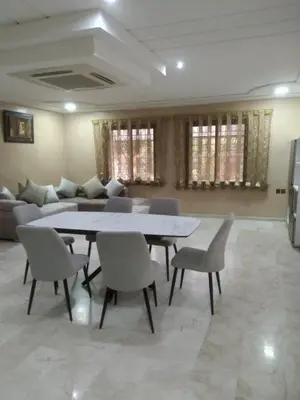 a living room with a table and chairs and a couch at Villa Alhambra in Fès