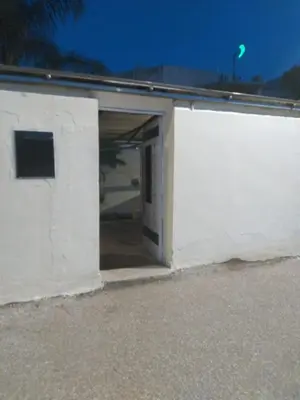 a white building with an open garage door at Villa Alhambra in Fès