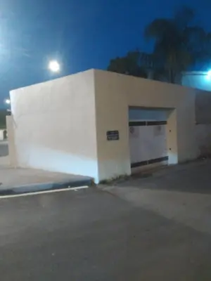 a white building with a garage at night at Villa Alhambra in Fès