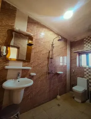 a bathroom with a sink and a shower and a toilet at Moussa in Oulad Akkou