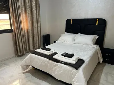 a bedroom with a bed with towels on it at Luxe University Apartment 1 in Fès