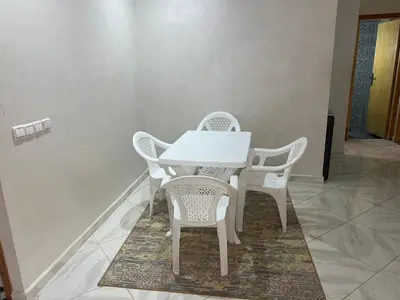 a white table and chairs in a room at Luxe University Apartment 1 in Fès