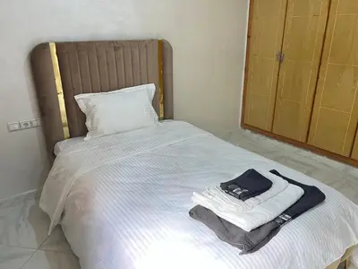 a bed with towels and a bag on top of it at Luxe University Apartment 1 in Fès