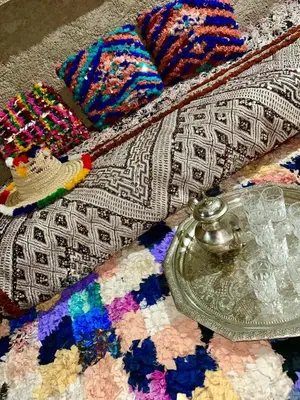 a close up of a rug with a glass dish on it at Havre de paix à la campagne in El Hajeb