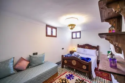 a bedroom with a bed and a couch at Dar Yanis in Fès
