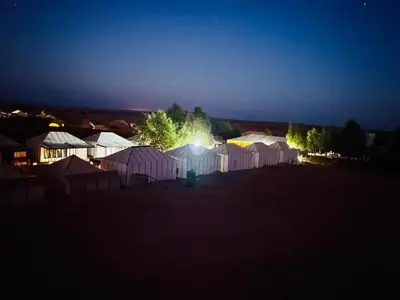 a group of tents in a field at night at Dar Yanis in Fès