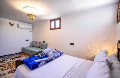 a bedroom with a bed and a couch in it at Dar Yanis in Fès