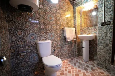 a bathroom with a toilet and a sink at Dar Yanis in Fès