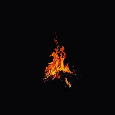 a fire is burning in the dark at Nomad Haven Luxury Camp in Merzouga