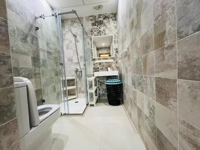 a bathroom with a shower and a sink and a toilet at Colina Smir par Immo Marina Vacances de Rêve D2-4 in Oulad Akkou