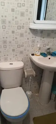 a bathroom with a toilet and a sink at Modern Furnished Apartment in Imouzzer Kandar