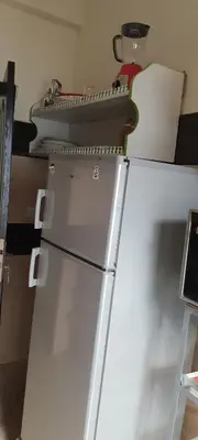 a white refrigerator with a machine on top of it at Modern Furnished Apartment in Imouzzer Kandar