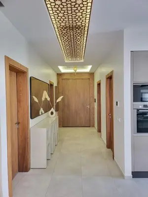 a hallway with wooden doors and a hallway with a hallwayngth at Villa Madjeyalia Soft Luxury in Marrakech