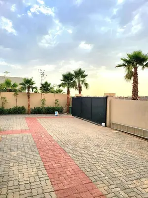 a brick driveway with palm trees in the background at Villa Madjeyalia Soft Luxury in Marrakech