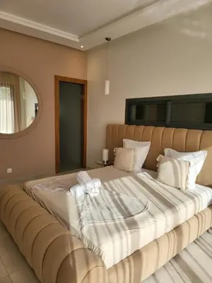 a bedroom with a large bed with a large white blanket at Villa Madjeyalia Soft Luxury in Marrakech