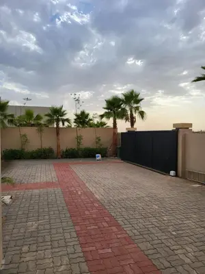 a brick patio with palm trees and a fence at Villa Madjeyalia Soft Luxury in Marrakech