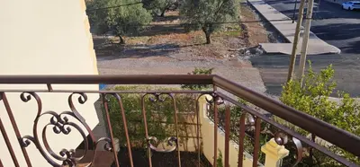 a balcony with a wrought iron railing and a street at Atlas stay in Fès