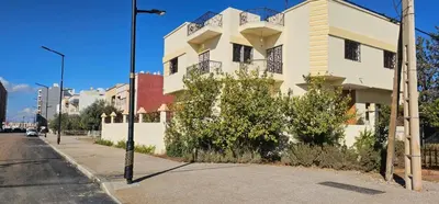 a white building on the side of a street at Atlas stay in Fès