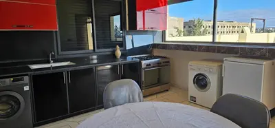 a kitchen with a washing machine and a washer and dryer at Atlas stay in Fès