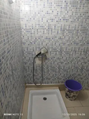 a shower in a tiled bathroom with a tub at Studio riad zitouna in Meknès