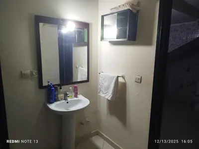 a bathroom with a sink and a mirror at Studio riad zitouna in Meknès