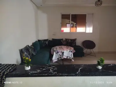 a living room with a couch and a table at Studio riad zitouna in Meknès