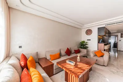 a living room with a couch and a table at Urban Pearl Refined and bright in Oulad Akkou