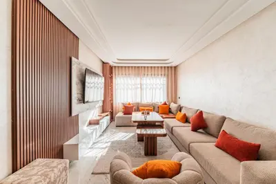 a living room with a couch and a table at Urban Pearl Refined and bright in Oulad Akkou
