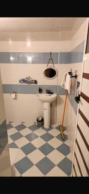 a small bathroom with a sink and a toilet at Spacious apartment in Fès