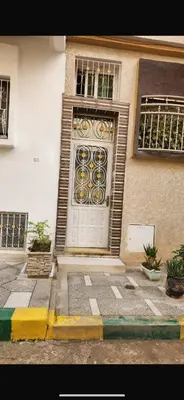 a building with a white door with a window at Spacious apartment in Fès