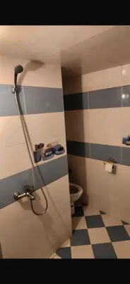 a bathroom with a shower with a toilet in it at Spacious apartment in Fès
