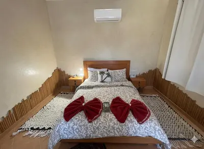 a bedroom with a bed with bows on it at Najma Ourika in Ourika