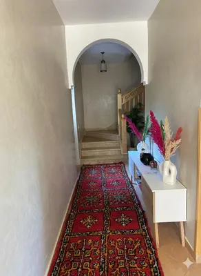 a hallway with a rug on the floor and a stairway at Najma Ourika in Ourika
