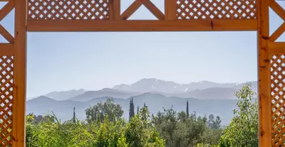 a view of the mountains through a window at Najma Ourika in Ourika