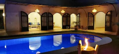 a house with a swimming pool in the yard at Najma Ourika in Ourika