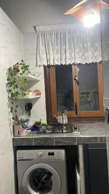 a kitchen with a stove and a washing machine at Dar Ghita in Fès