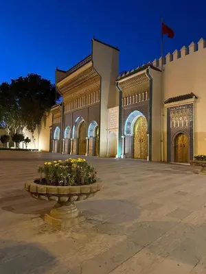 a large building with a fountain in front of it at Dar Ghita in Fès