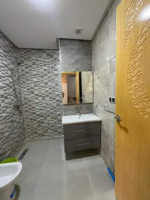 a bathroom with a sink and a toilet and a mirror at Hote othmane in Beni Mellal